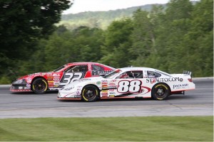 Jean-Paul Cyr (32VT) and Nick Sweet (88VT) battle for position in last Sunday's 50-lap Late Model Race at Thunder Road.  Cyr is currently tied with David Pembroke for the points lead, with last year's Champion Sweet two points behind them in third.  All three competitors are former Thunder Road Champions.  (Photo Credit: Alan Ward)