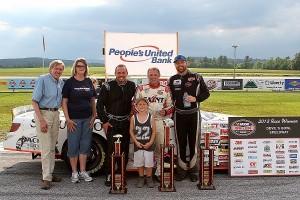 (L-R) Broadcaster Ken Squier, People's United Bank Financial Services Manager Sharon Kendall (Fair Haven, VT), Josh Masterson, Nick Sweet, and Chip Grenier in People's United Bank 100 victory lane in 2013 at Devil's Bowl Speedway.  (MemorEvents photo)
